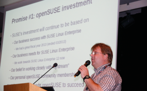 Abbildung 6: Ralf Flaxa, Suses Vizepräsident fürs Engineering, ist stolz auch auf Open Suse und stellt seinen Plan für die weitere Zusammenarbeit vor.
