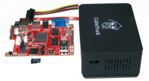 Abbildung 3: Links im Bild die Platine des Cubietruck, davor liegt die Micro-SD-Karte, dahinter SATA- und Konsolenkabel, rechts das zusätzliche Gehäuse.